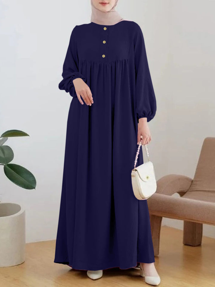Damer elegant maxikjol med knappdetalj och voluminösa ärmar Mirla-Eva Jonsson
