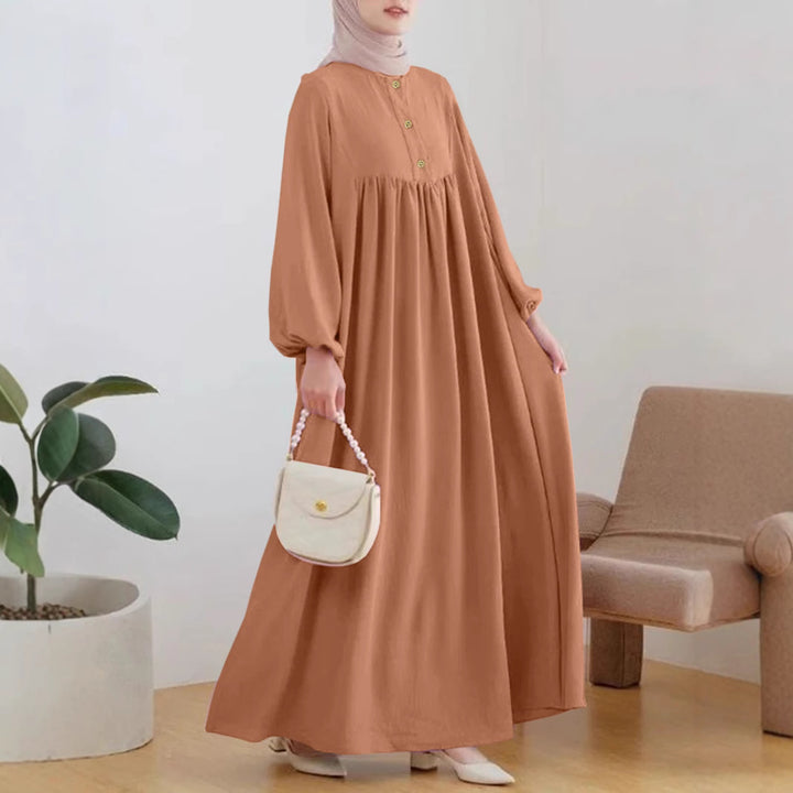 Damer elegant maxikjol med knappdetalj och voluminösa ärmar Mirla-Eva Jonsson