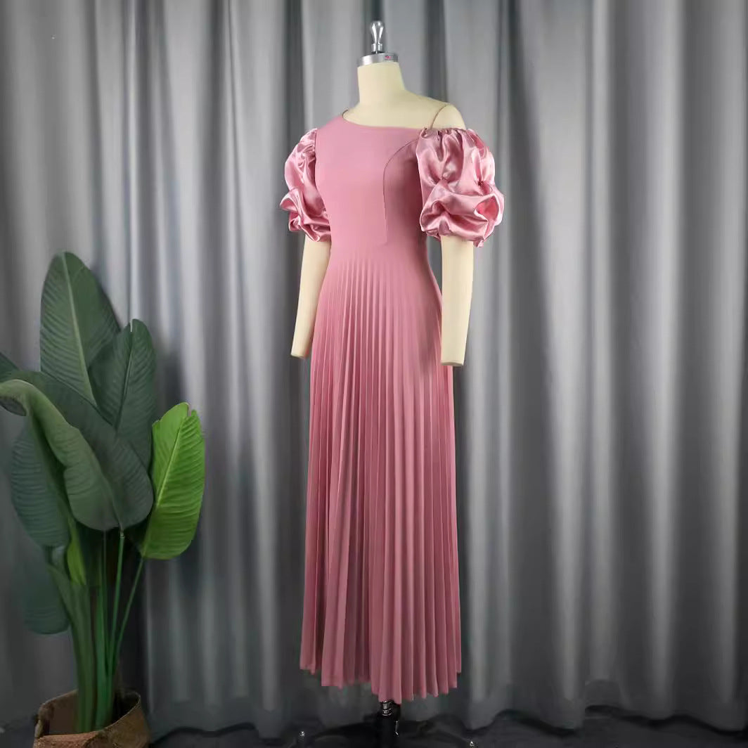 Damer elegant maxiklänning med asymmetrisk skärning och voluminösa puffärmar Mirla-Eva Jonsson
