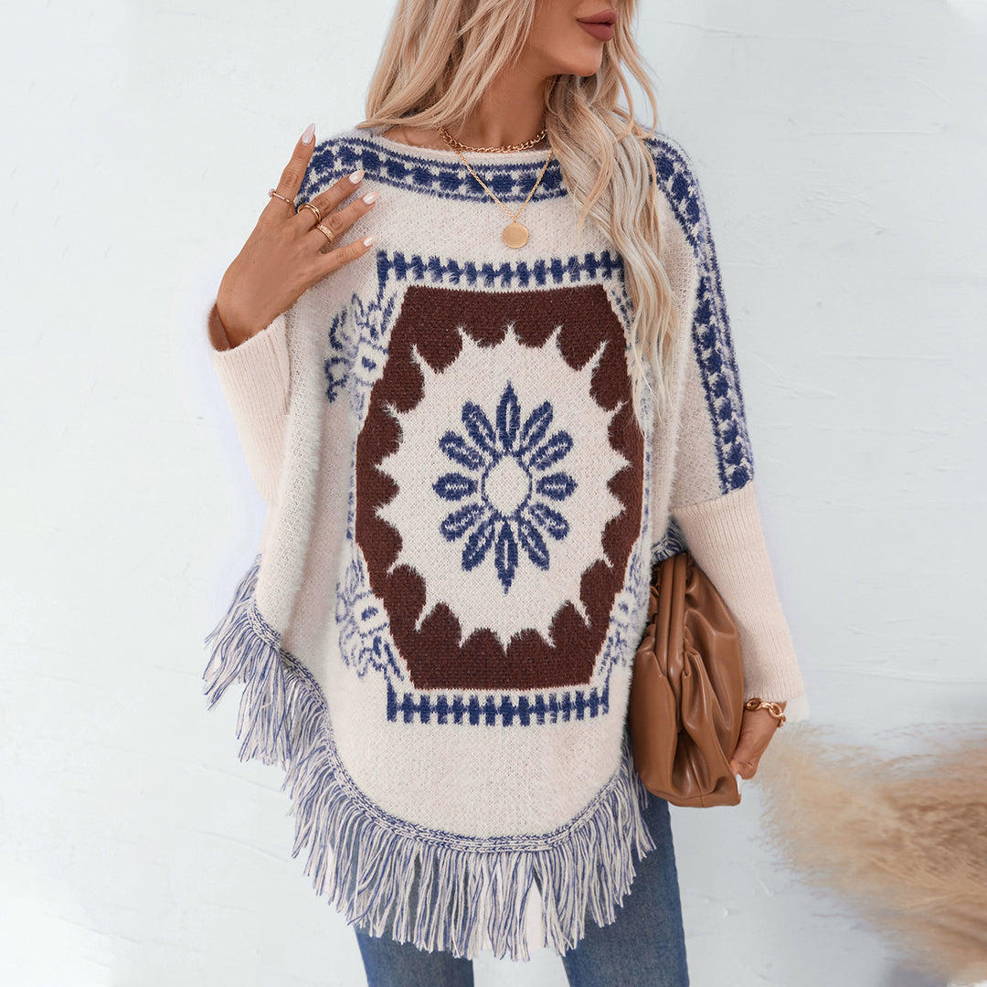 Damer elegant stickad poncho med konstfullt mönster och fransig avslutning Mirla-Eva Jonsson