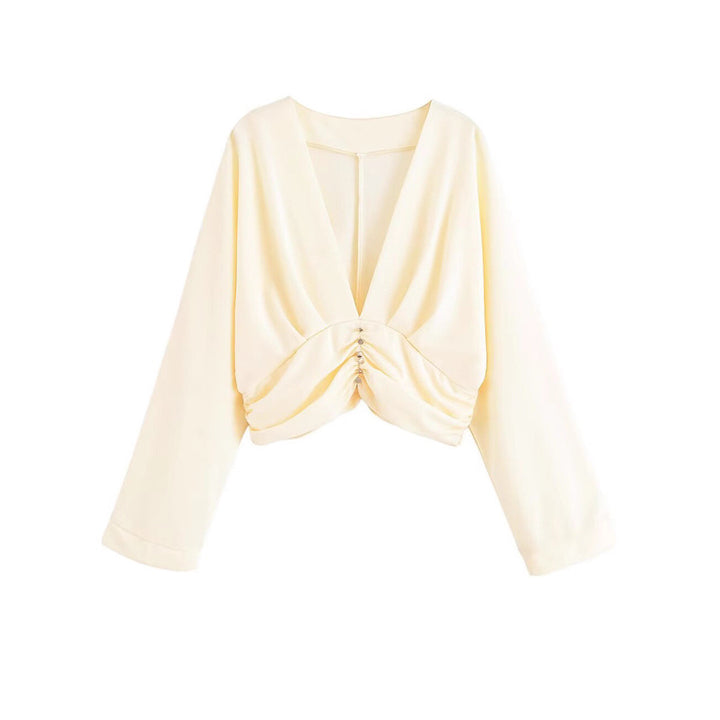 Damer elegant topp med djup V-ringning och raffinerad volangdesign Mirla-Eva Jonsson