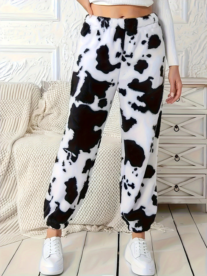 Damer fritidshose i avslappnat cow-print-design med elastisk midja och muddar Mirla-Eva Jonsson