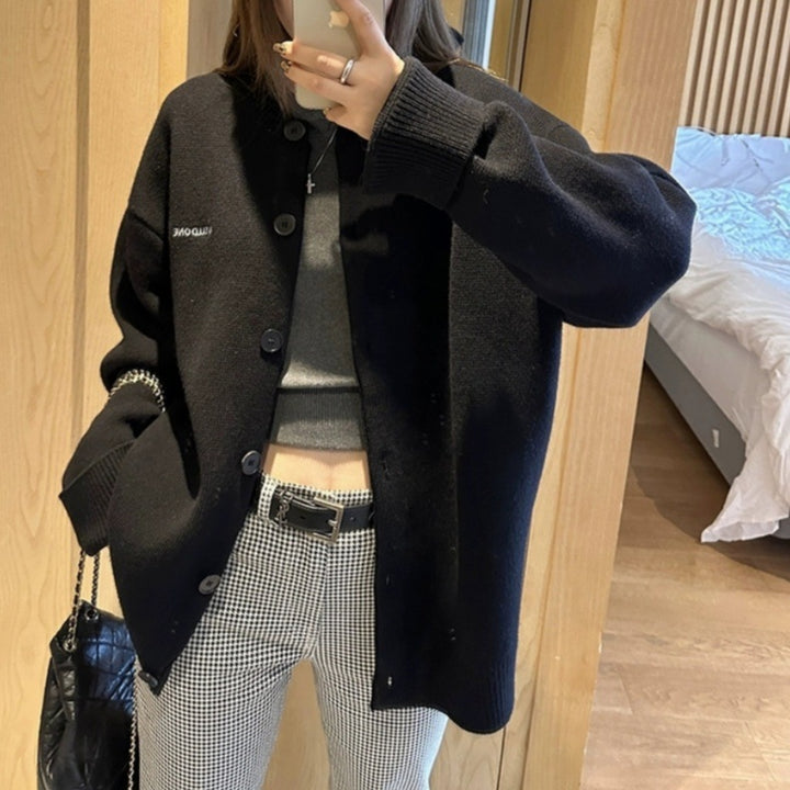 Damer stilren stickad cardigan med knapplist och broderad logotyp Mirla-Eva Jonsson