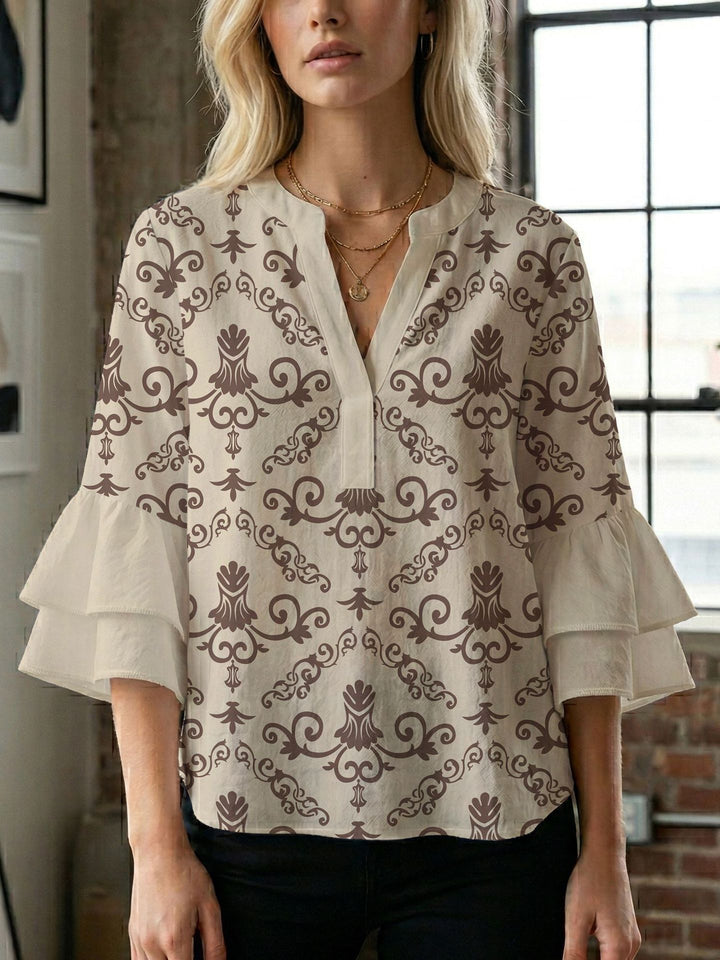 Damern blusenshirt med voluminösa ärmar och kreativt tryckdesign Mirla-Eva Jonsson