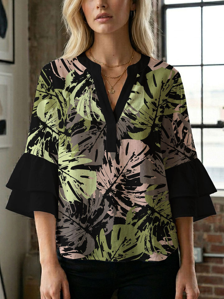 Damern blusenshirt med voluminösa ärmar och kreativt tryckdesign Mirla-Eva Jonsson