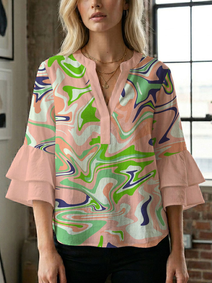 Damern blusenshirt med voluminösa ärmar och kreativt tryckdesign Mirla-Eva Jonsson
