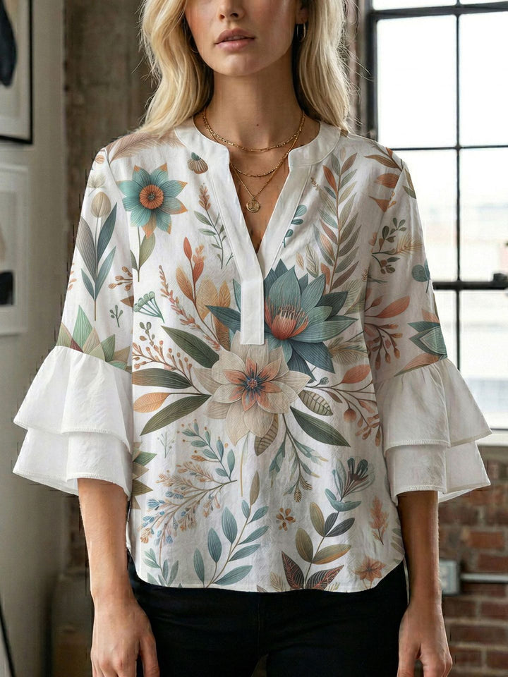 Damern blusenshirt med voluminösa ärmar och kreativt tryckdesign Mirla-Eva Jonsson