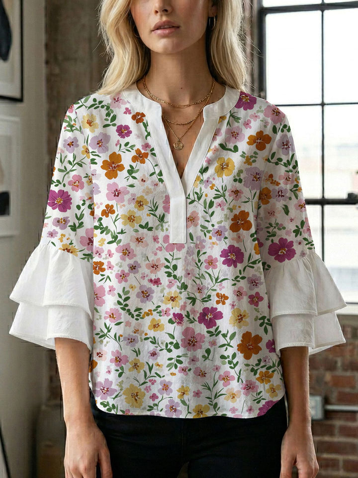 Damern blusenshirt med voluminösa ärmar och kreativt tryckdesign Mirla-Eva Jonsson