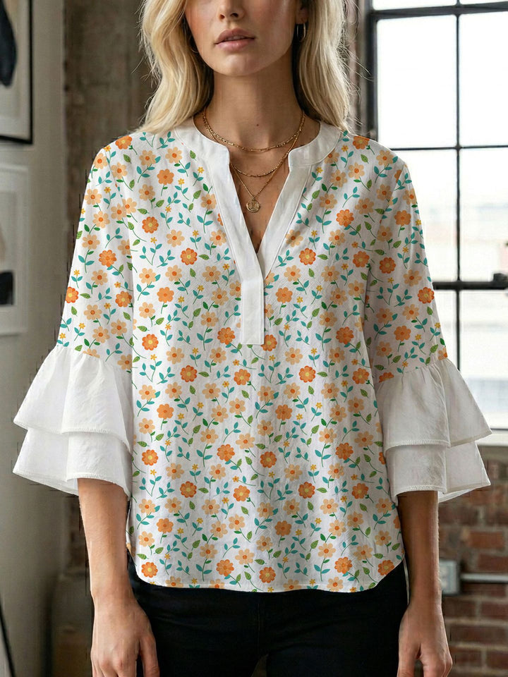 Damern blusenshirt med voluminösa ärmar och kreativt tryckdesign Mirla-Eva Jonsson