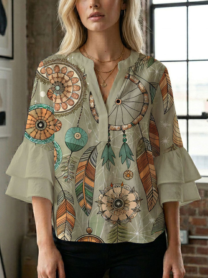 Damern blusenshirt med voluminösa ärmar och kreativt tryckdesign Mirla-Eva Jonsson
