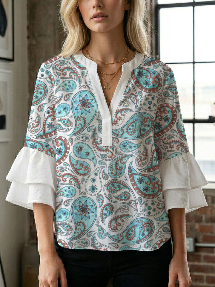 Damern blusenshirt med voluminösa ärmar och kreativt tryckdesign Mirla-Eva Jonsson