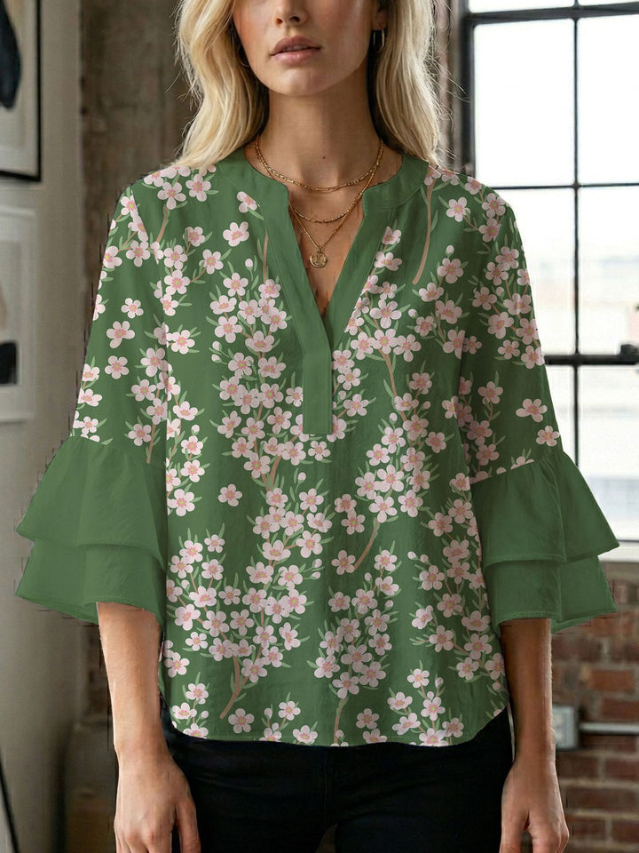 Damern blusenshirt med voluminösa ärmar och kreativt tryckdesign Mirla-Eva Jonsson