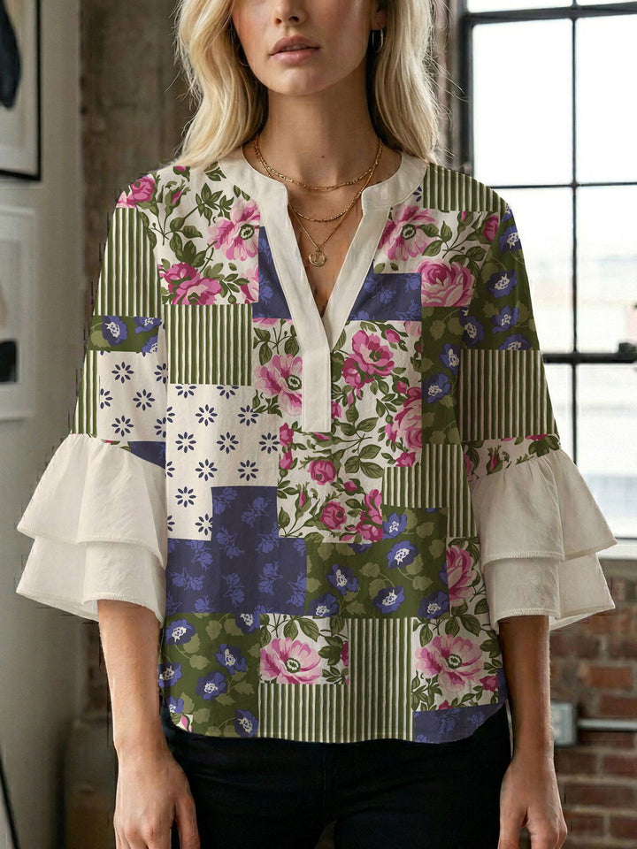 Damern blusenshirt med voluminösa ärmar och kreativt tryckdesign Mirla-Eva Jonsson