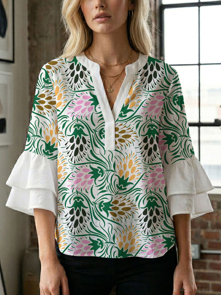 Damern blusenshirt med voluminösa ärmar och kreativt tryckdesign Mirla-Eva Jonsson