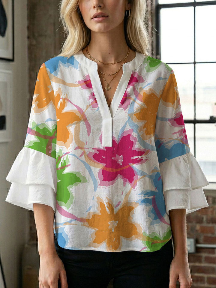 Damern blusenshirt med voluminösa ärmar och kreativt tryckdesign Mirla-Eva Jonsson