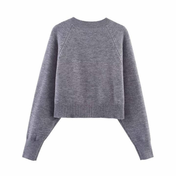 Damern cropped stickad jacka med knappdetaljer och elastisk midja Mirla-Eva Jonsson