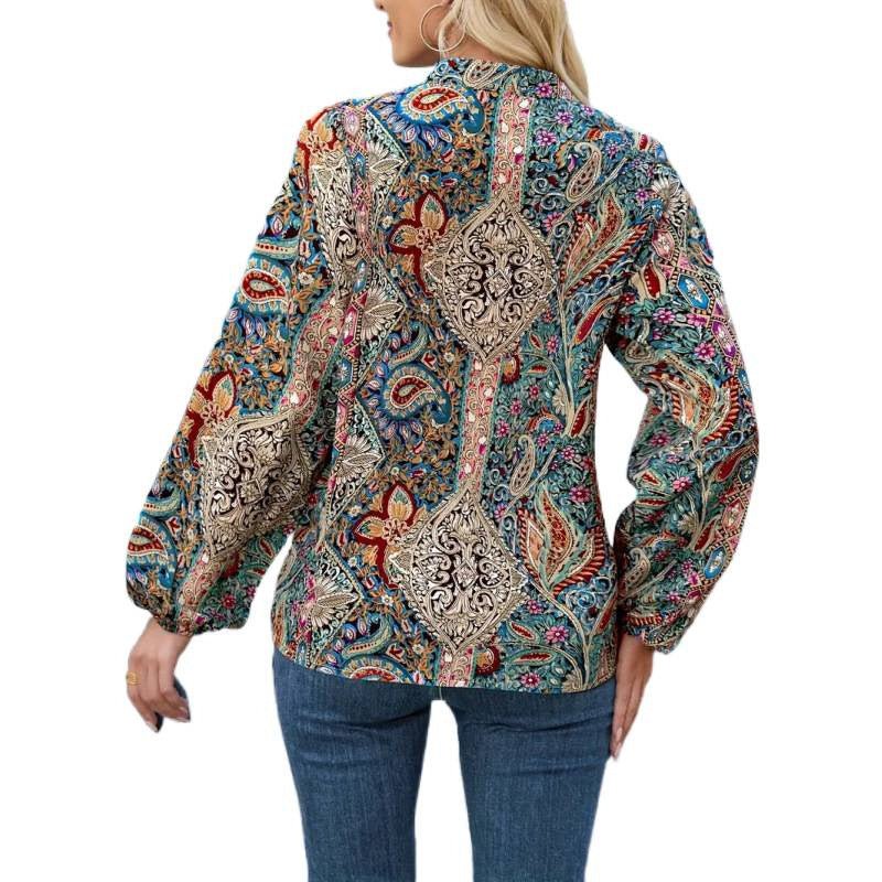 Damern elegant blus med färggt tryck och extravaganta puffärmar Mirla-Eva Jonsson