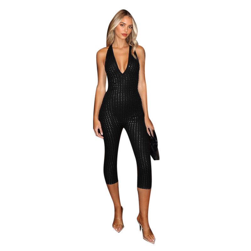 Damern figurnära jumpsuit med djup V-urringning och nätliknande design Mirla-Eva Jonsson
