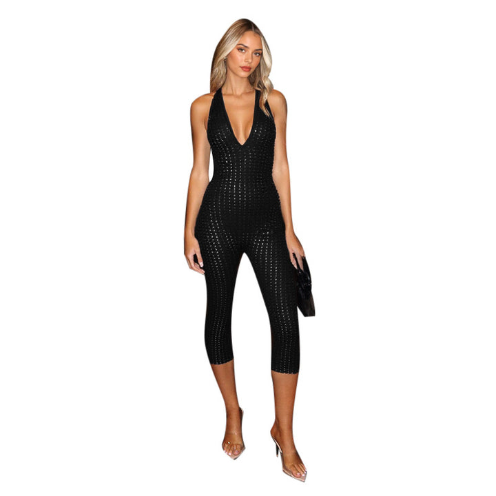 Damern figurnära jumpsuit med djup V-urringning och nätliknande design Mirla-Eva Jonsson