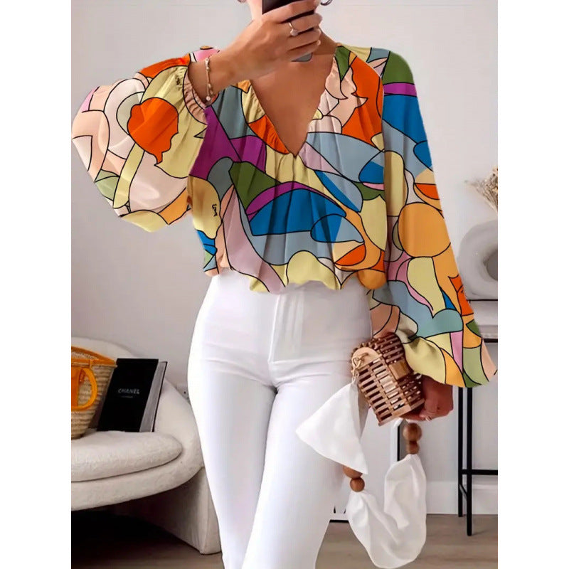 Damern oversized blus med färgglad grafisk mönster och vida ärmar Mirla-Eva Jonsson