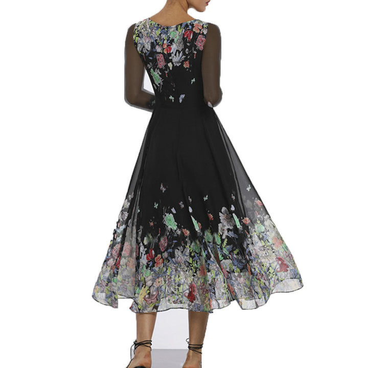 Damernas Eleganta Blomma-Maxi-Klänning med Transparanta Ärmar och Flödande Snitt Mirla-Eva Jonsson