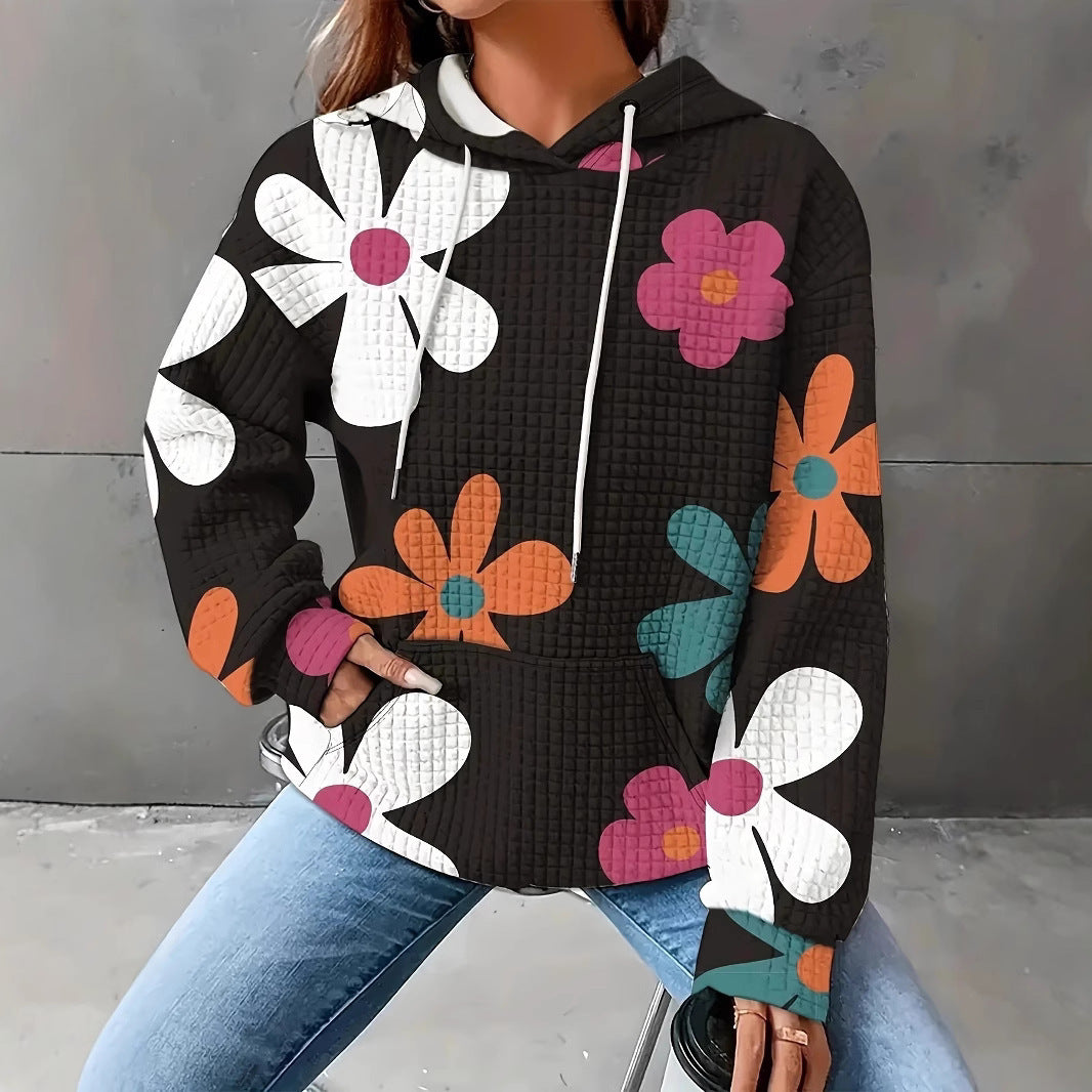 Damernas avslappnad huvtröja med färgglad blommönster Mirla-Eva Jonsson