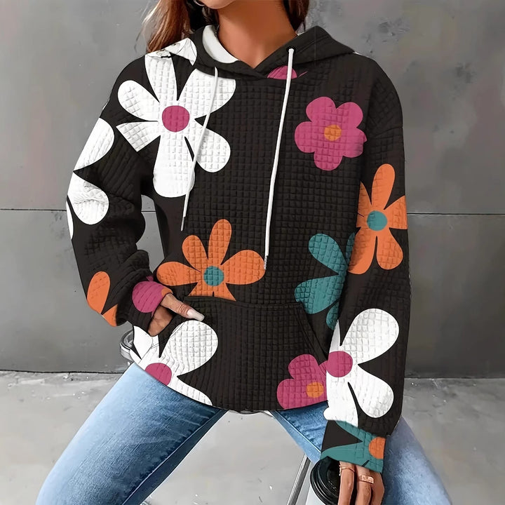 Damernas avslappnad huvtröja med färgglad blommönster Mirla-Eva Jonsson