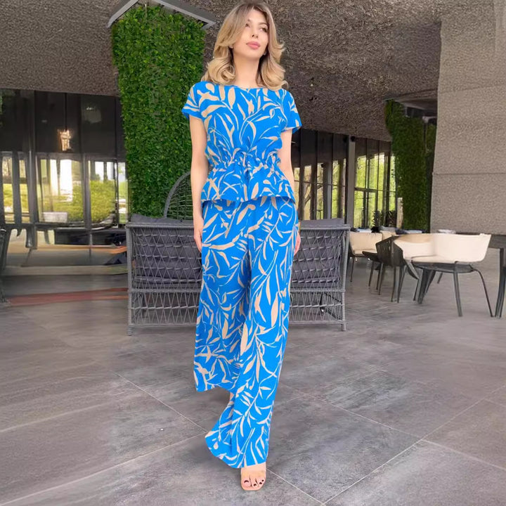 Damernas flödande jumpsuit med blommönster och elastisk midja Mirla-Eva Jonsson