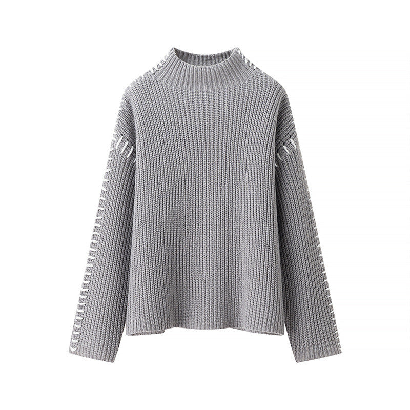 Damernas mode stickad tröja med hög krage och eleganta sidos detaljer Mirla-Eva Jonsson