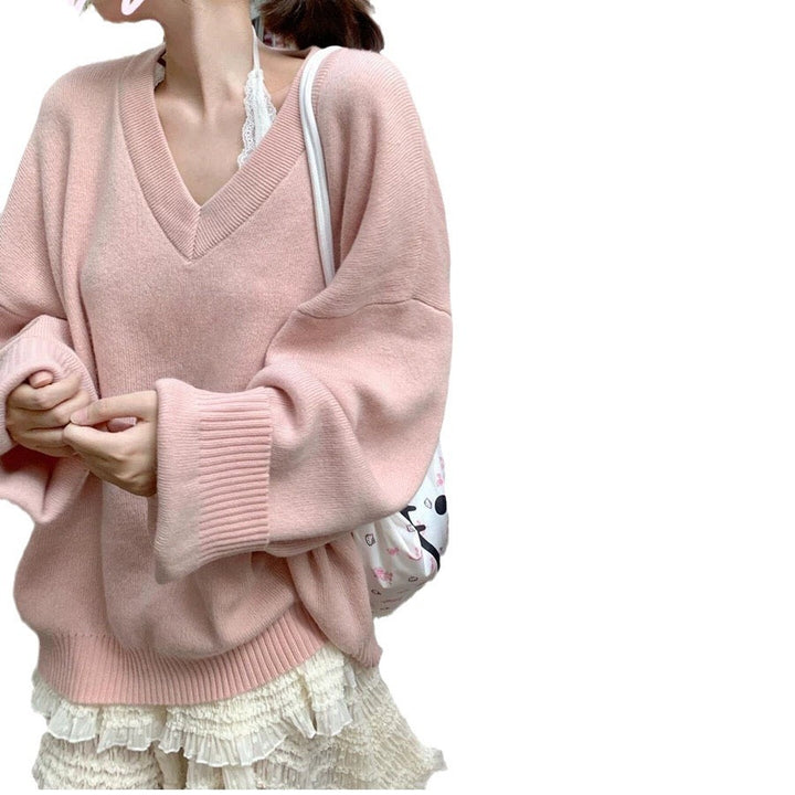 Damernas oversized V-halsad tröja med avslappnade raglanärmar och strukturerad design Mirla-Eva Jonsson