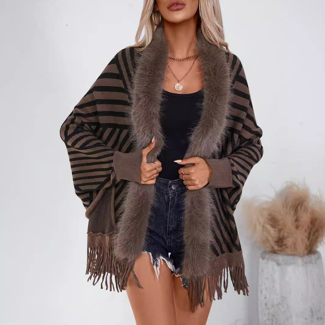 Damernas stickponcho med elegant krage av konstpäls och fransig design Mirla-Eva Jonsson