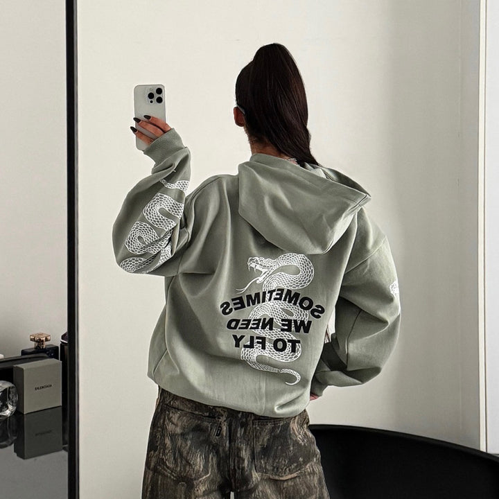 Damernas stiliga hoodie med grafiskt tryck och överskott ärmar Mirla-Eva Jonsson