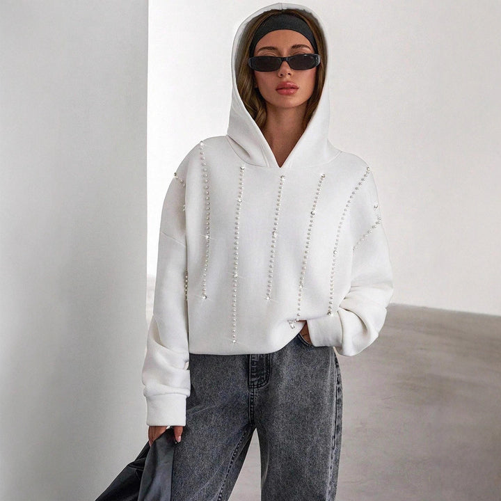 Damernas trendiga oversized hoodie med eleganta pärldetaljer Mirla-Eva Jonsson