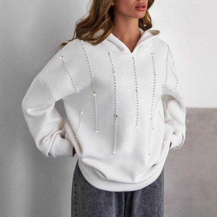 Damernas trendiga oversized hoodie med eleganta pärldetaljer Mirla-Eva Jonsson