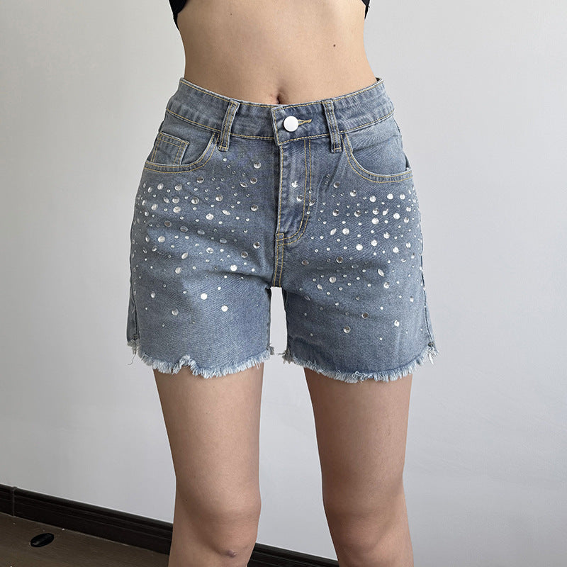 Damjeansshorts med glittrande applikationer och fransad fåll Mirla-Eva Jonsson