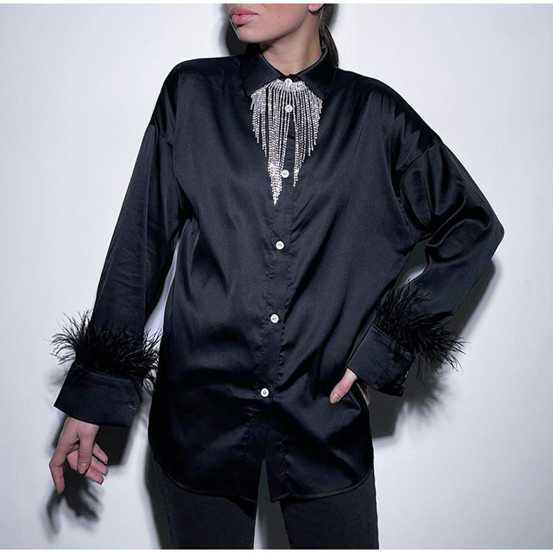 Damn blus med extravaganta fjäderdetaile och skimrande satin Mirla-Eva Jonsson