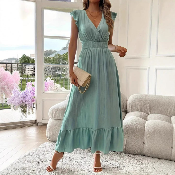 Dams Maxiklänning med voluminösa volangärmar och elegant midja Mirla-Eva Jonsson
