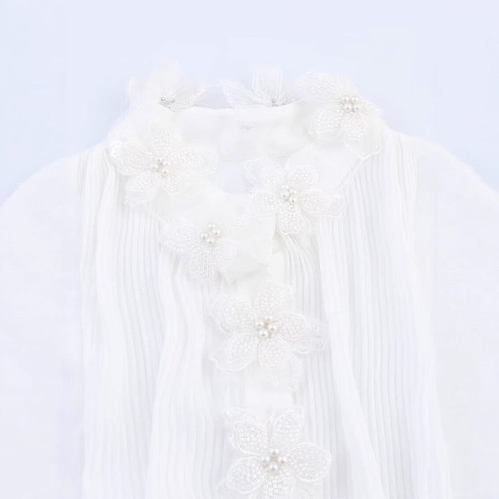 Dams elegant blus med blomsterapplikationer och skimrande detaljer Mirla-Eva Jonsson