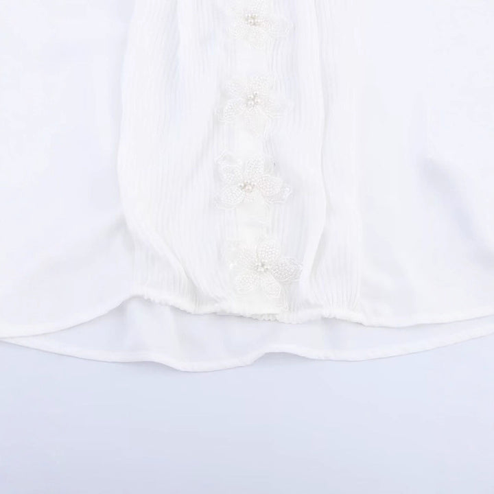 Dams elegant blus med blomsterapplikationer och skimrande detaljer Mirla-Eva Jonsson