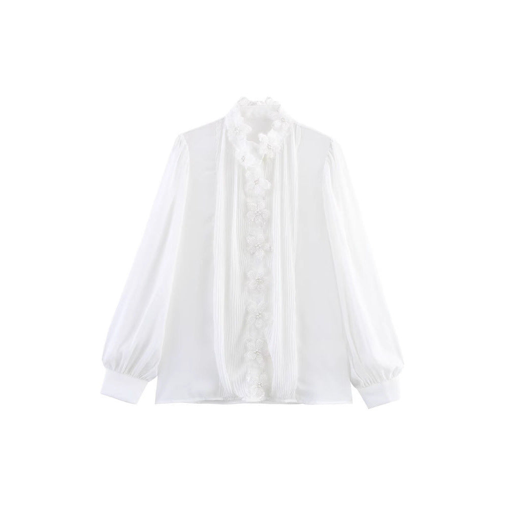 Dams elegant blus med blomsterapplikationer och skimrande detaljer Mirla-Eva Jonsson