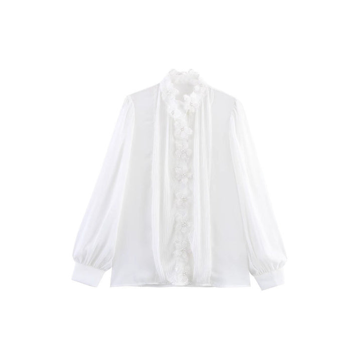Dams elegant blus med blomsterapplikationer och skimrande detaljer Mirla-Eva Jonsson