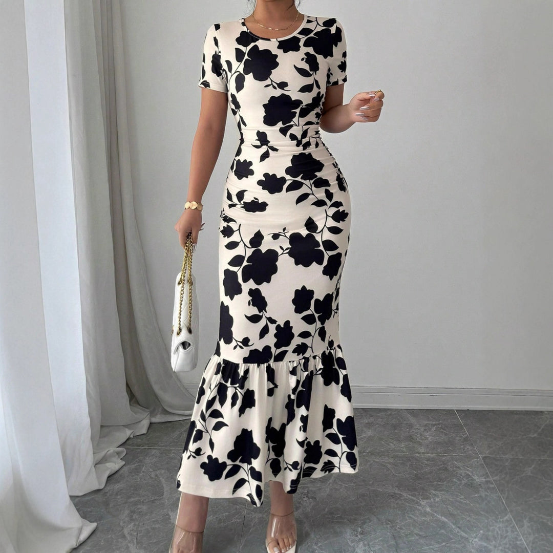 Dams elegant figurnära klänning med volangslut och blommönster Mirla-Eva Jonsson