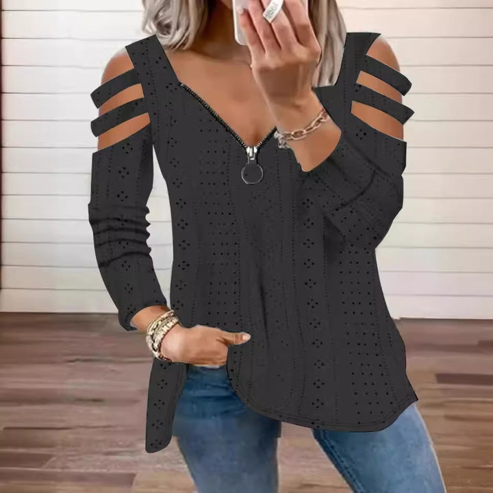 Damsk stickad topp med moderna cut-outs och dragkedja Mirla-Eva Jonsson