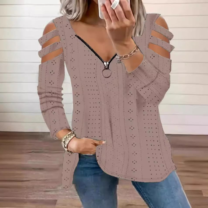 Damsk stickad topp med moderna cut-outs och dragkedja Mirla-Eva Jonsson