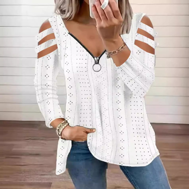 Damsk stickad topp med moderna cut-outs och dragkedja Mirla-Eva Jonsson