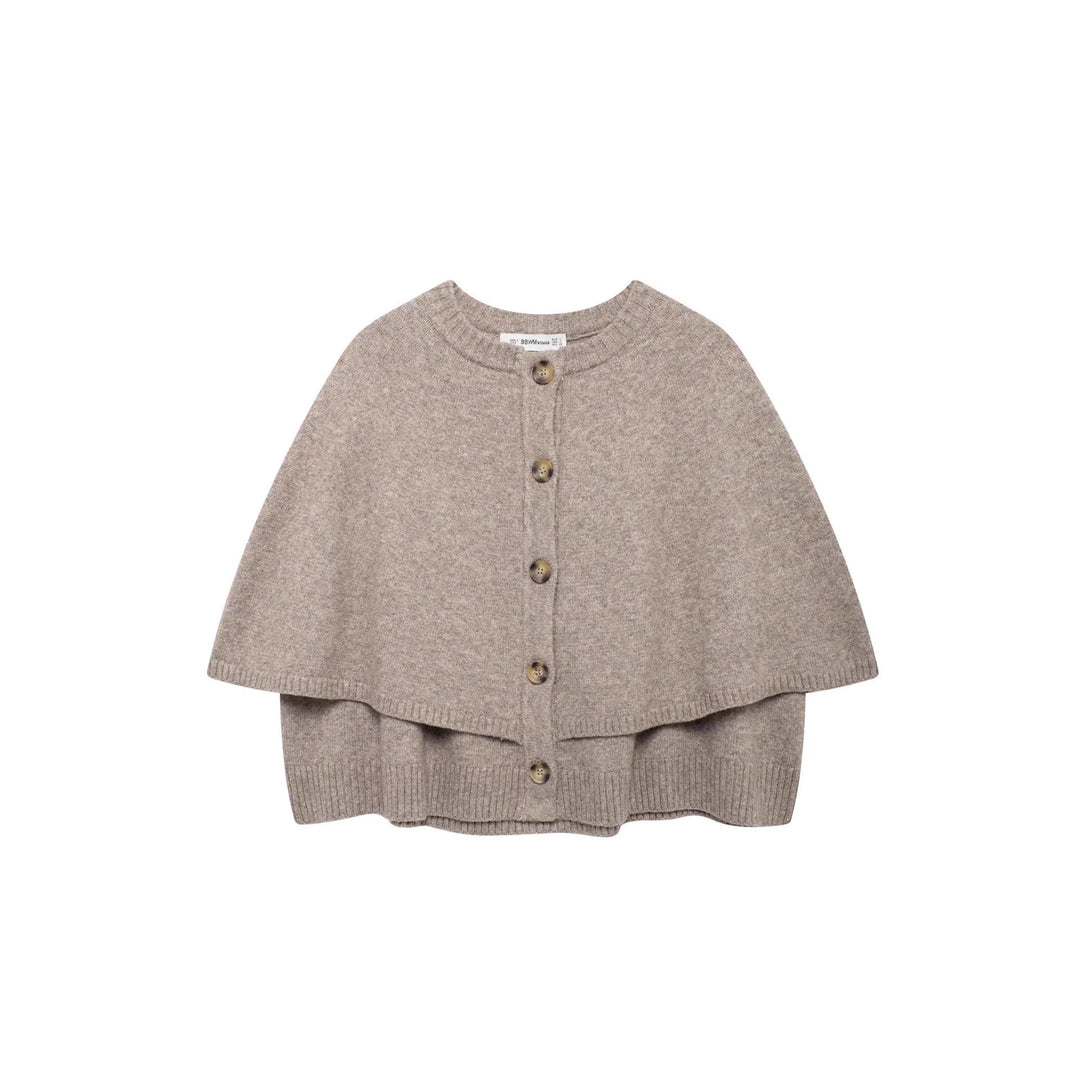 Damstickad poncho med knapppdetaljer Mirla-Eva Jonsson