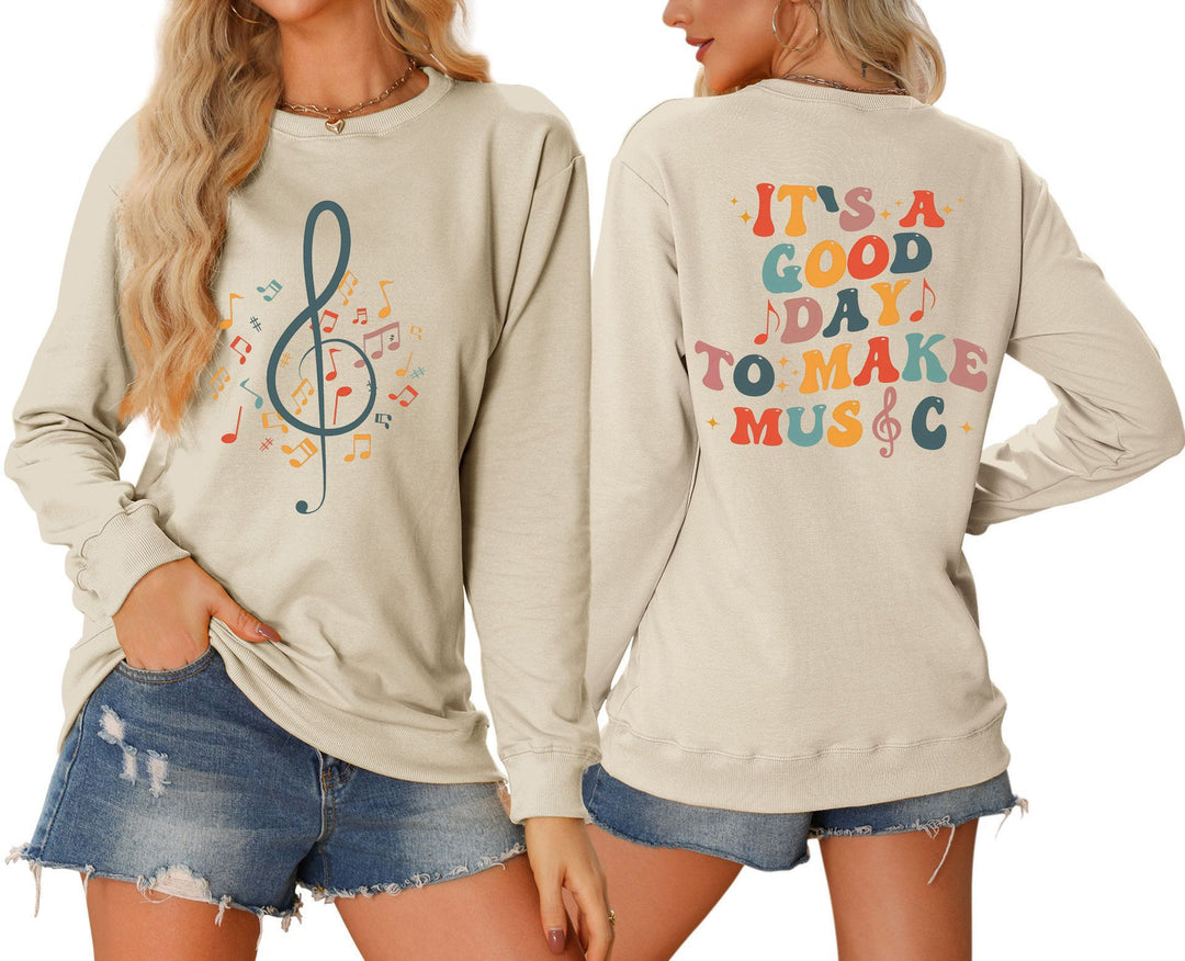 Damsweatshirt med musikaliskt motiv och kreativ text Mirla-Eva Jonsson