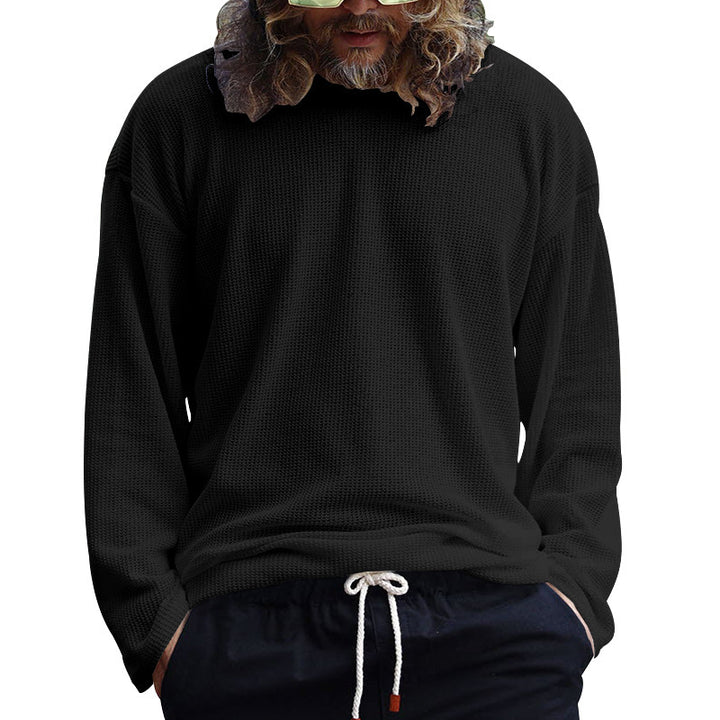 Herrens avslappnad långärmad T-shirt med strukturerad yta och modern rundhals. Mirla-Eva Jonsson