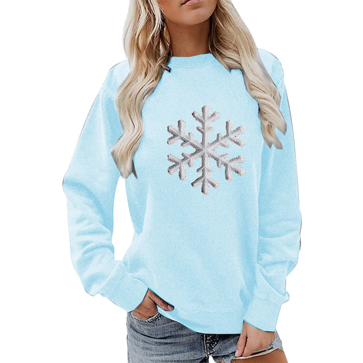 Kvinnas sweatshirt med glittrande snöflinge design och avslappnad passform Mirla-Eva Jonsson