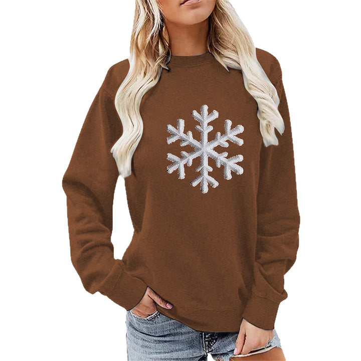 Kvinnas sweatshirt med glittrande snöflinge design och avslappnad passform Mirla-Eva Jonsson